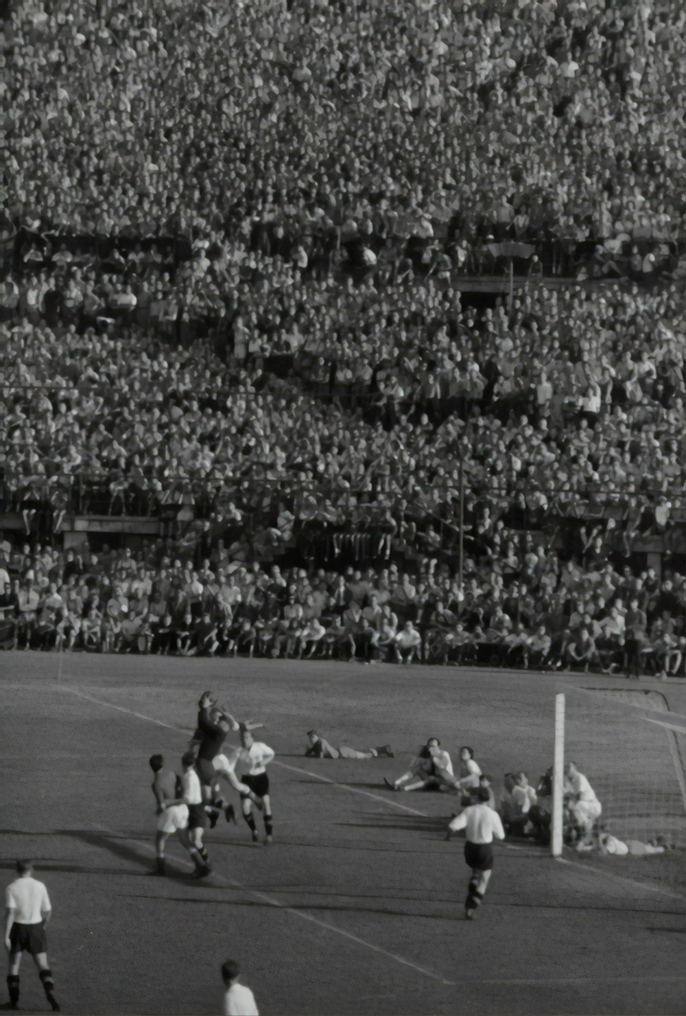 group of person playing soccer greyscale photograph