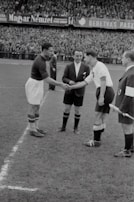 Referees and players shaking hands after a well-played match.