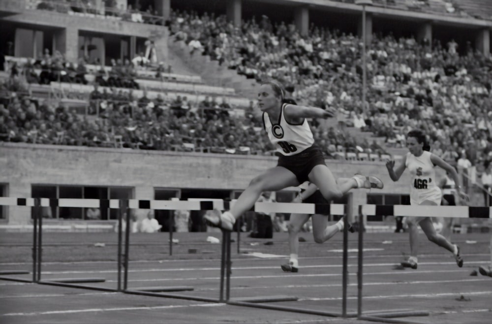 woman jumping on the hurdle photograph