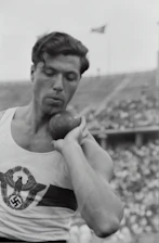 Black and white photo of a focused male student-athlete training intensely in a modern gym.