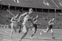 four man running on the field