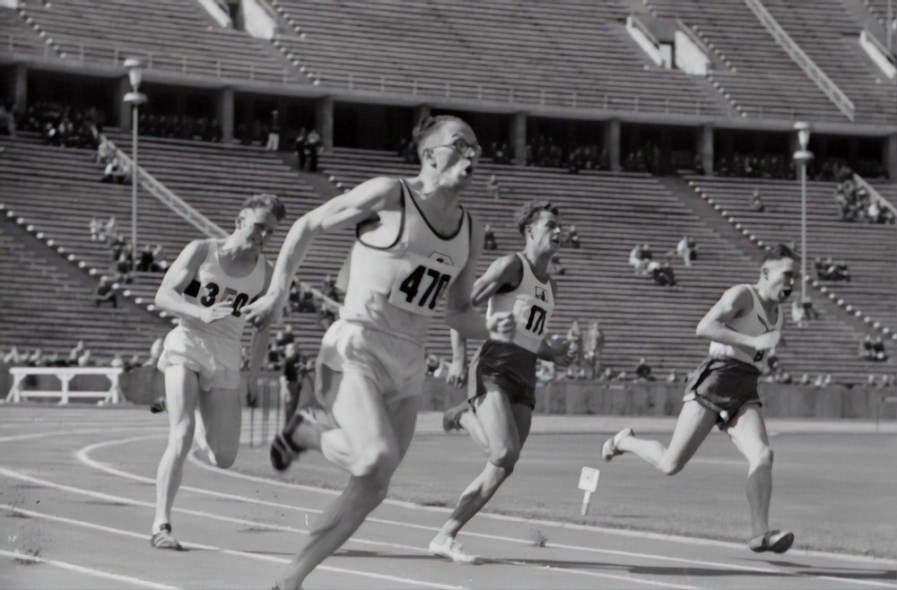 four man running on the field