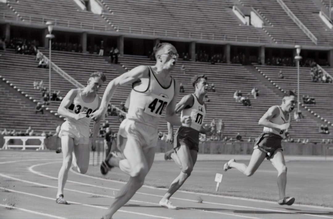 four man running on the field, Men