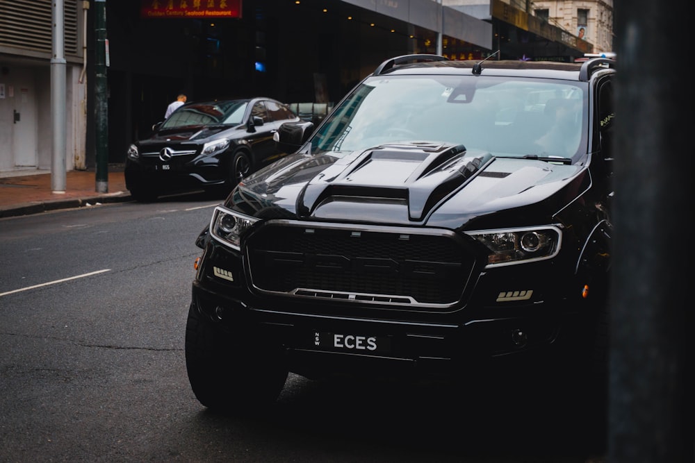 black vehicle parked on the side of street