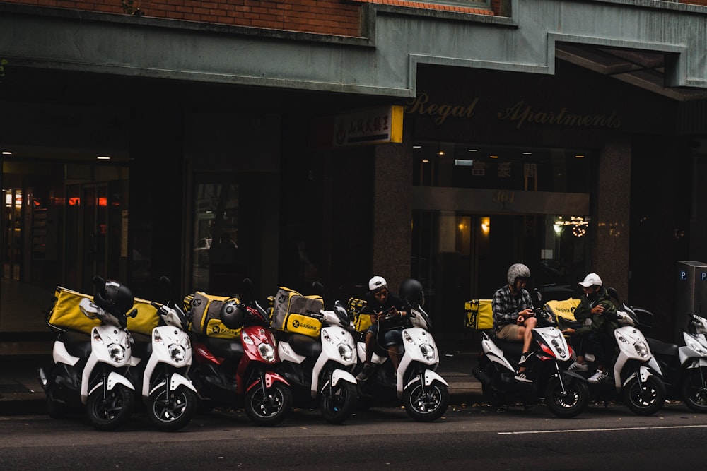 white and black sports bike parked beside brown building