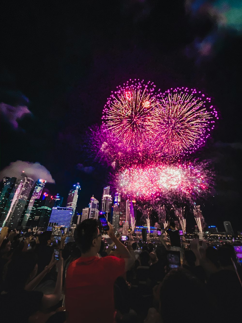 crowd watching pink fireworks