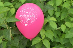 A delicate pink bubble balloon with a personalized message floating gently.