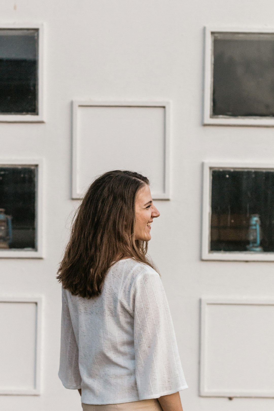 girl standing in front of white wall