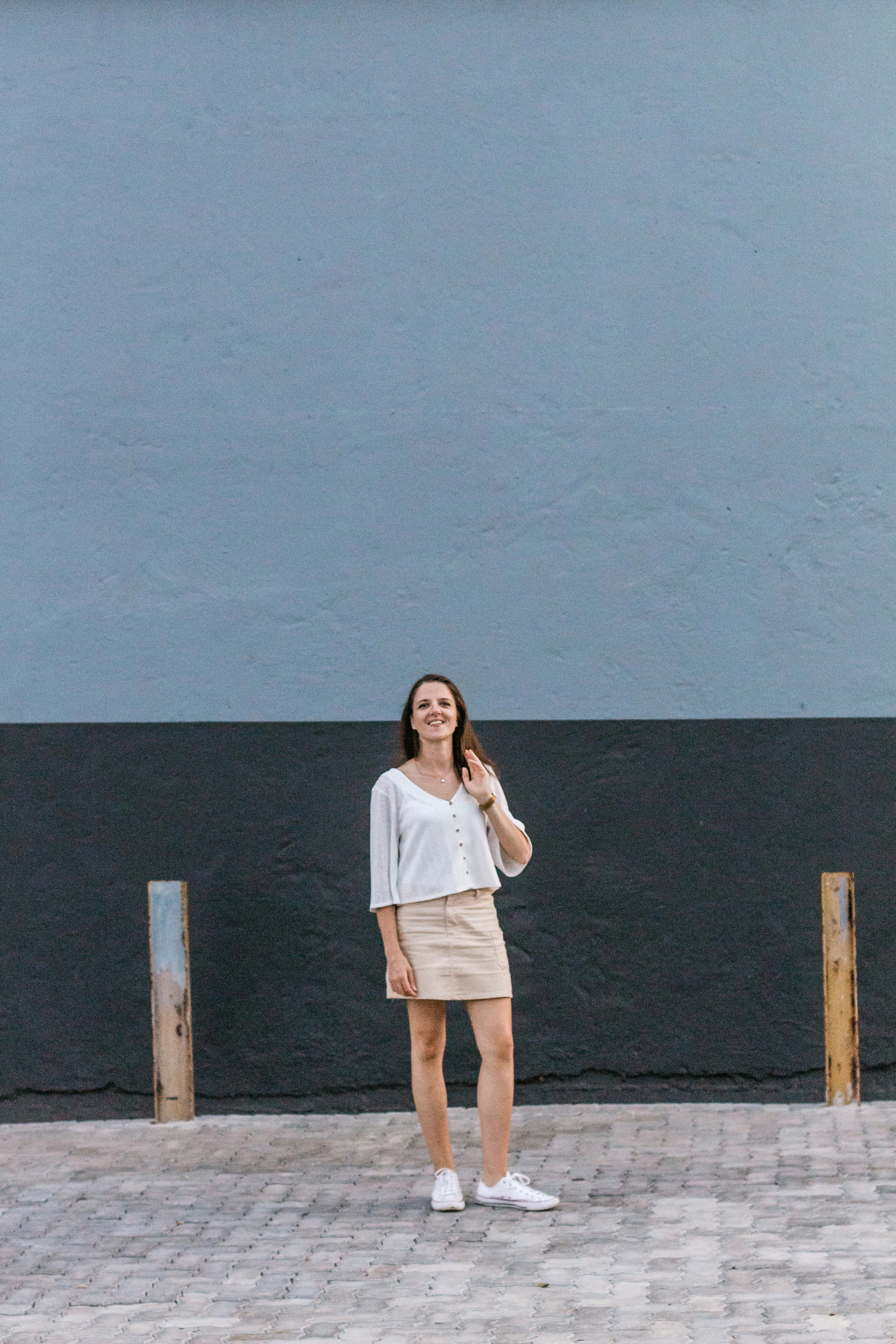 woman standing in front of gray and black-painted wall