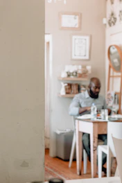 A person reviewing their bank statements at a cozy kitchen table.