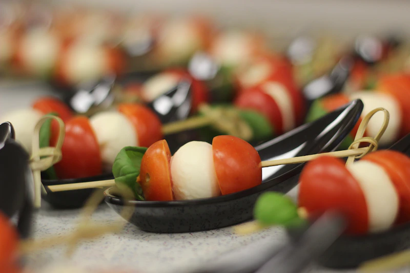 Tomato and mozzarella canapés served on tasting spoons