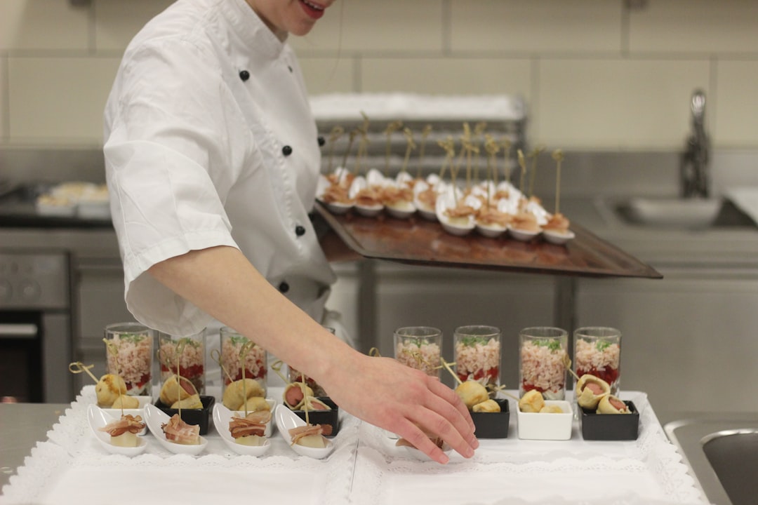 chef transferring food from tray, Cook placing fingerfood
