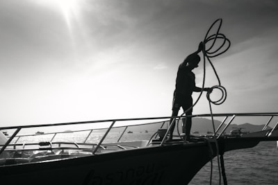 Crew members coordinating on the deck of a vessel during sunrise.