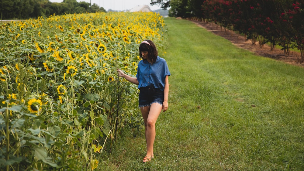 woman standing on sunflower field during daytime