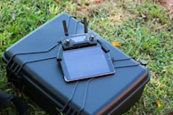 A drone operator analyzing data on a tablet.