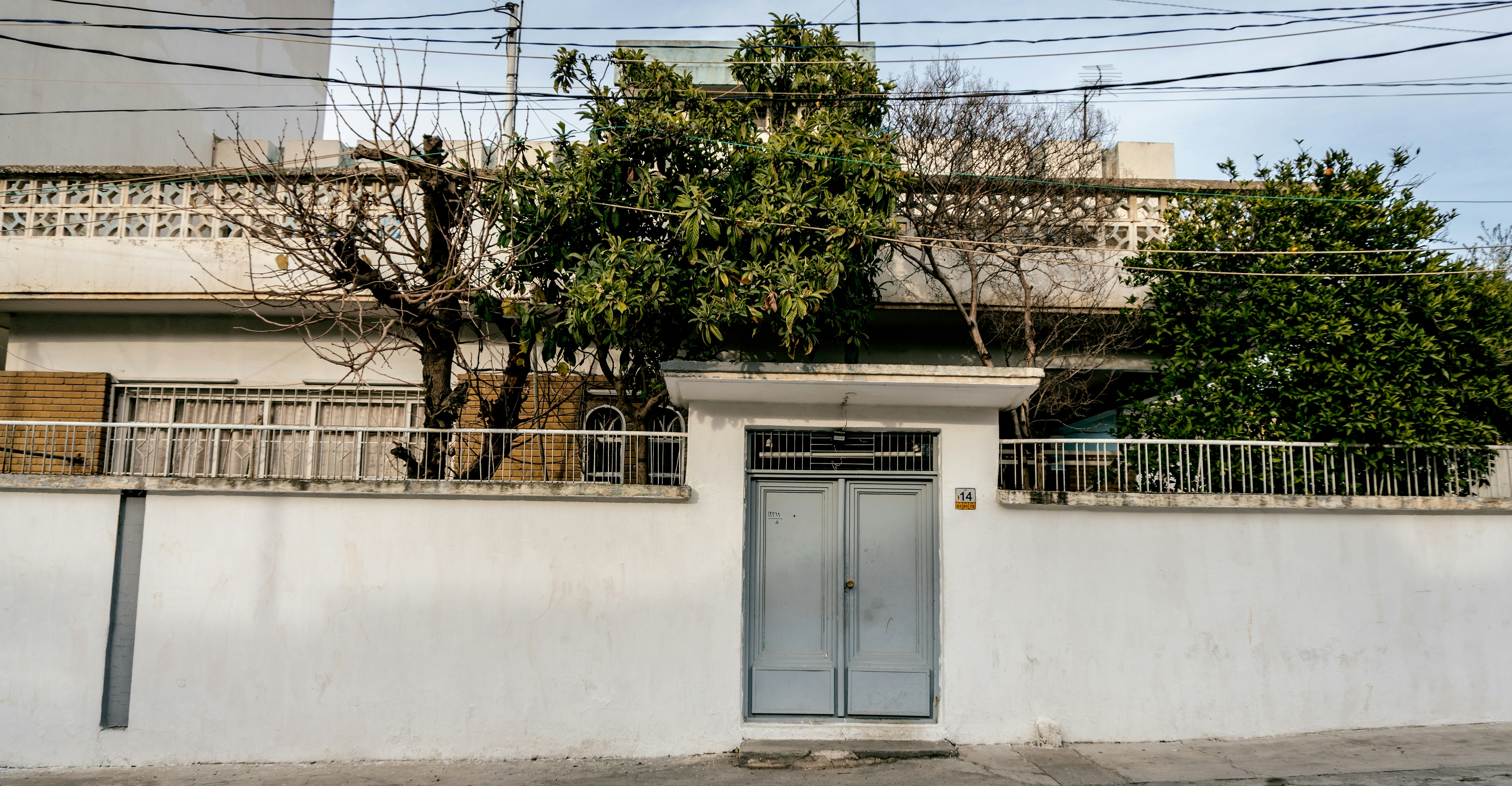 building with fence and closed gates during daytime