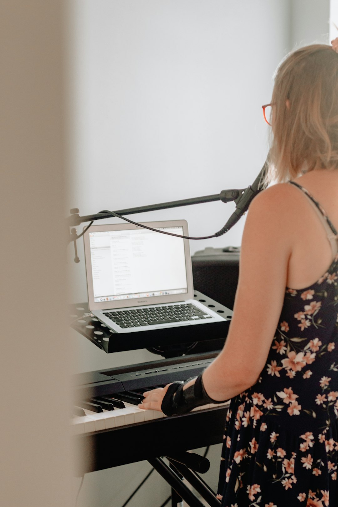 woman playing black electronic keyboard