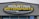 A large, rectangular business sign reads 'Mountain Motorsports' in bold letters. The text 'MOUNTAIN' is white, while 'MOTORSPORTS' is yellow, both set against a dark background. Above the text, there is an outline of mountain peaks in yellow.
