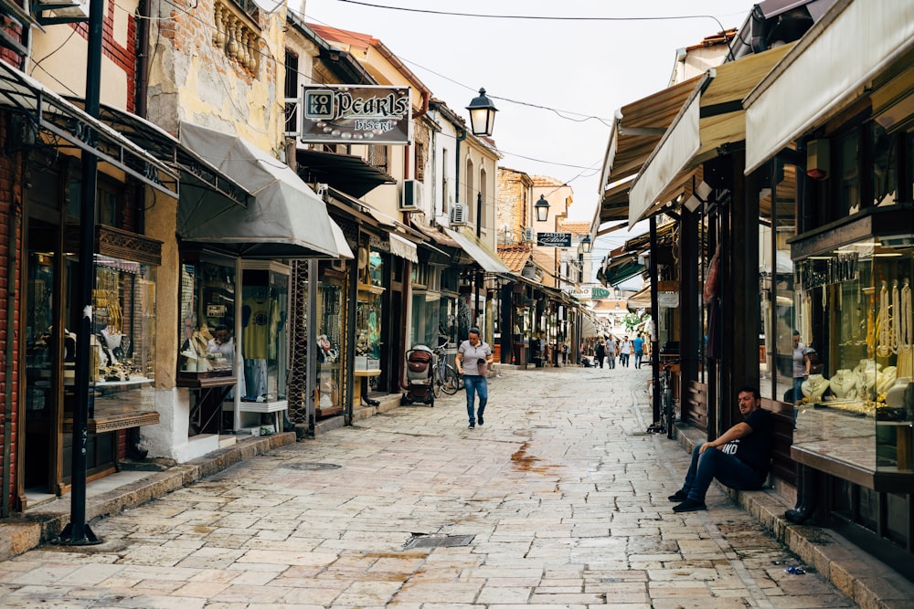 a person sitting on a bench in a street