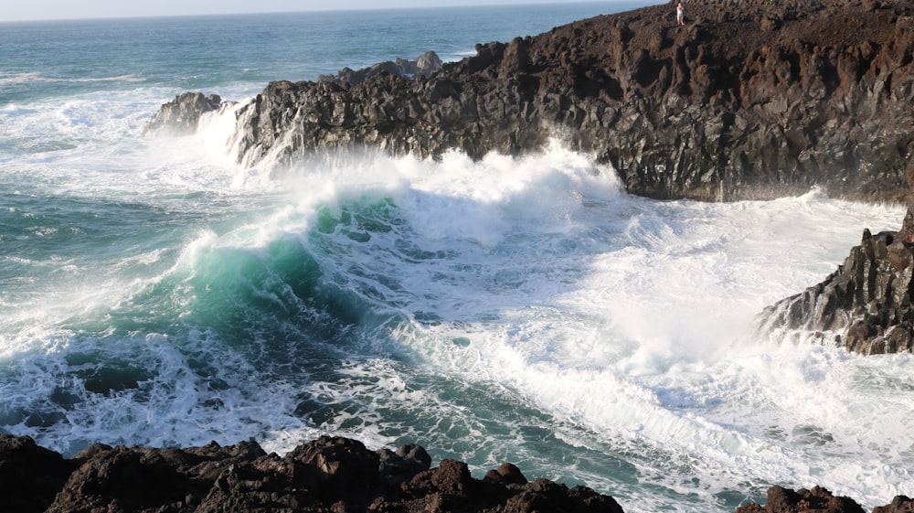 landscape photography of cliff near body of water during daytime