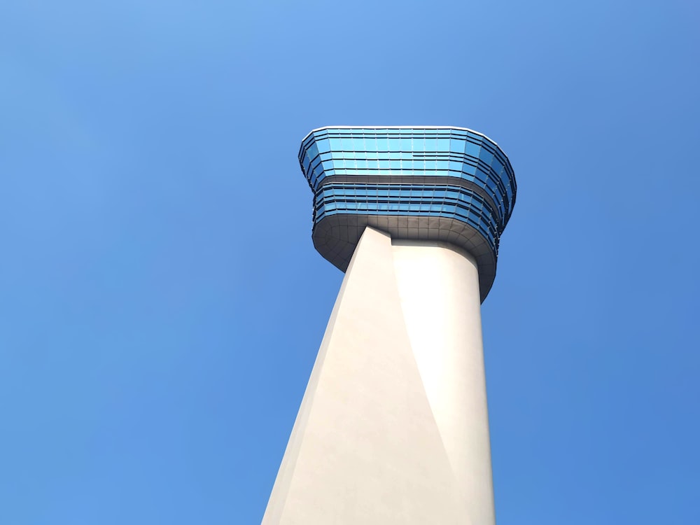 low-angle photography of white and blue tower building