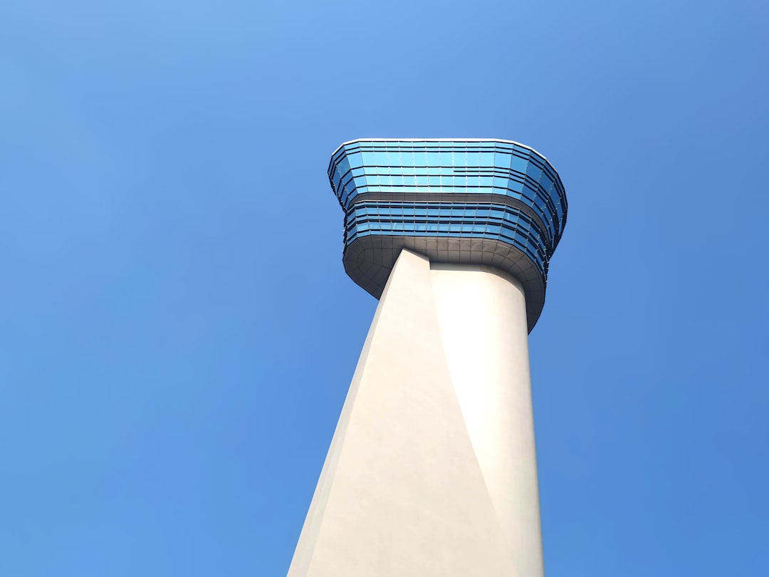 low-angle photography of white and blue tower building, ATC Tower at Bombay Airport (BOM)