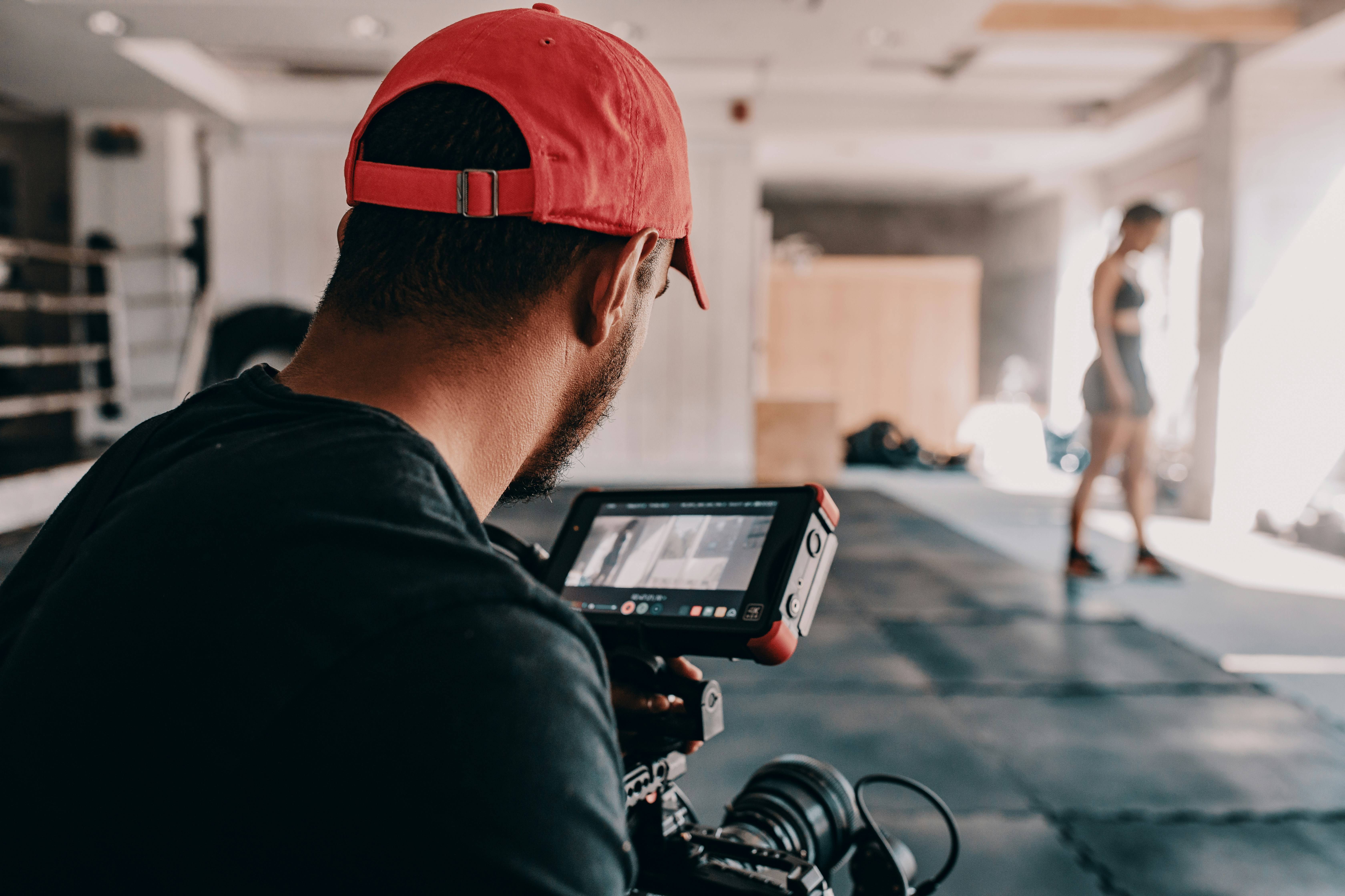 Man filming boxer ready to make sound effects for fight scenes