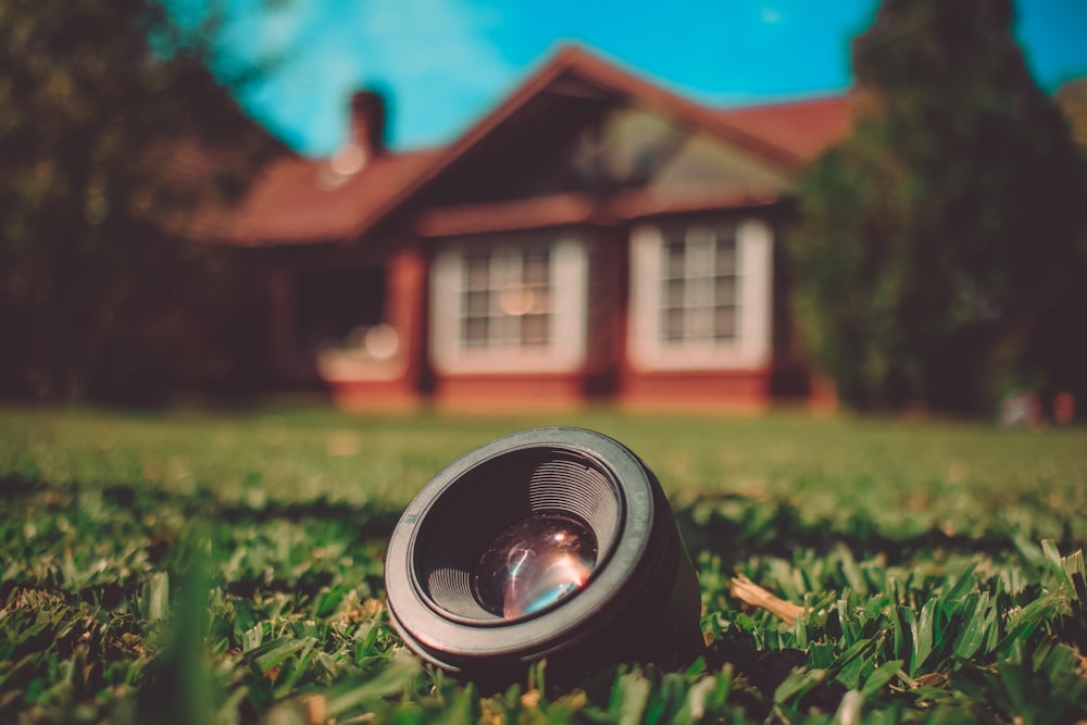 gray camera lens on grass during daytime