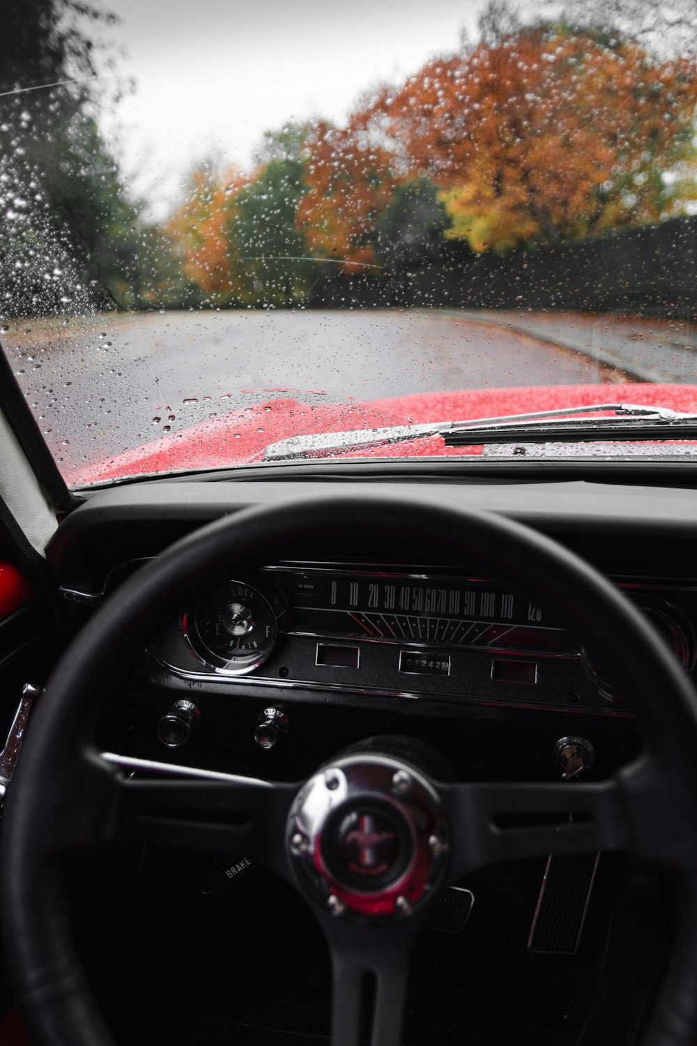 car on road during rain and day