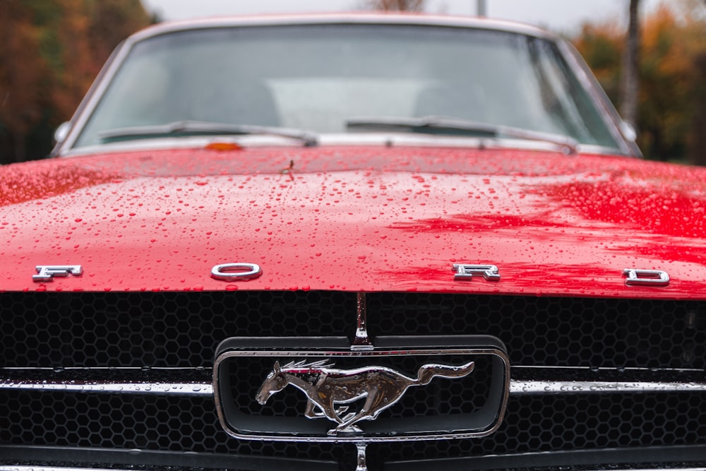 parked red Ford Mustang coupe during daytime