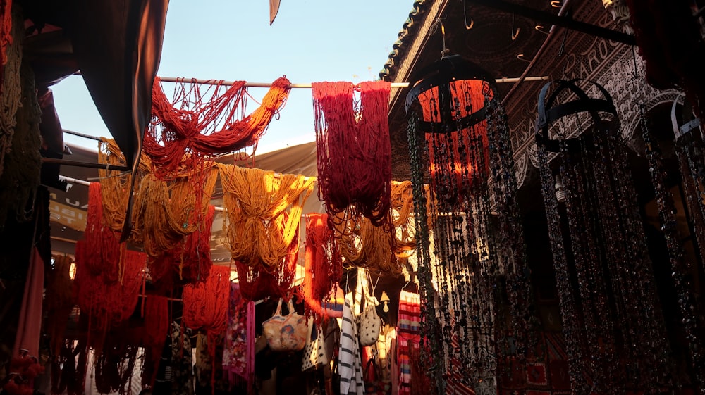 assorted hanging textiles between buildings during day