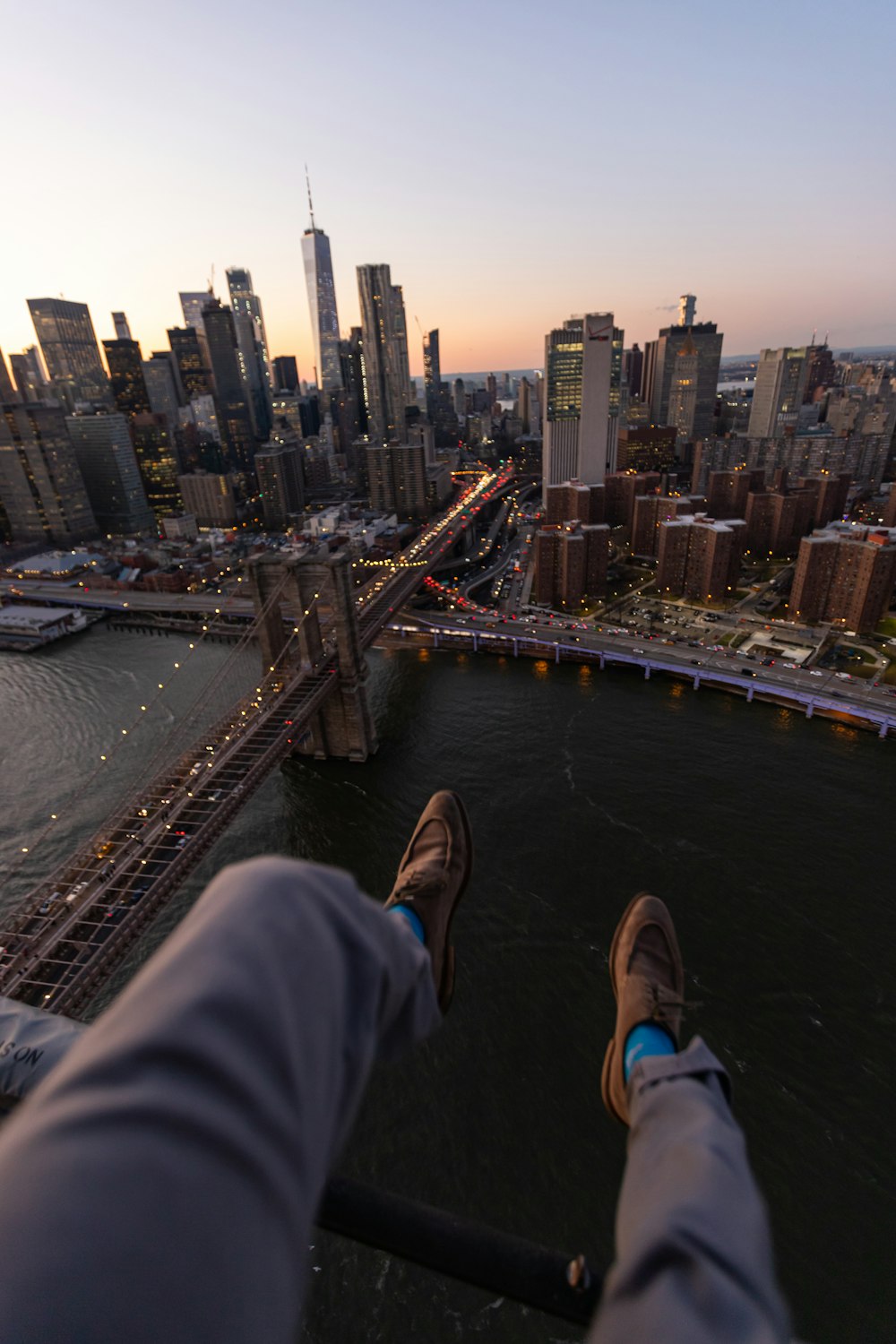 person in gray pants overlooking cityscape during daytime