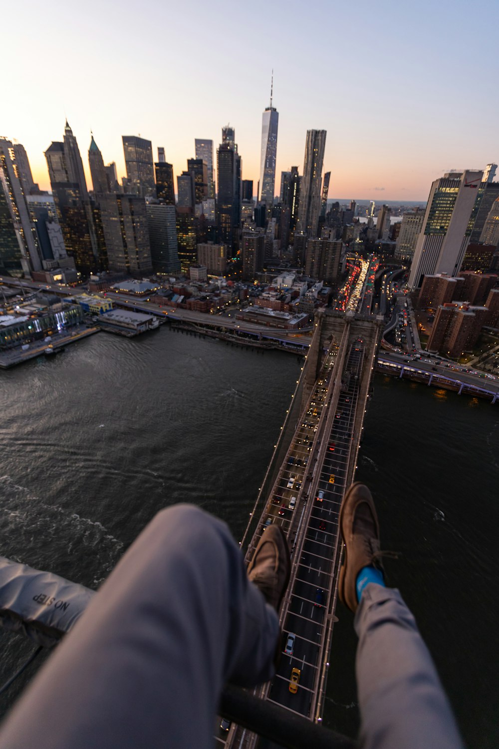 person in gray pants overlooking cityscape during daytime