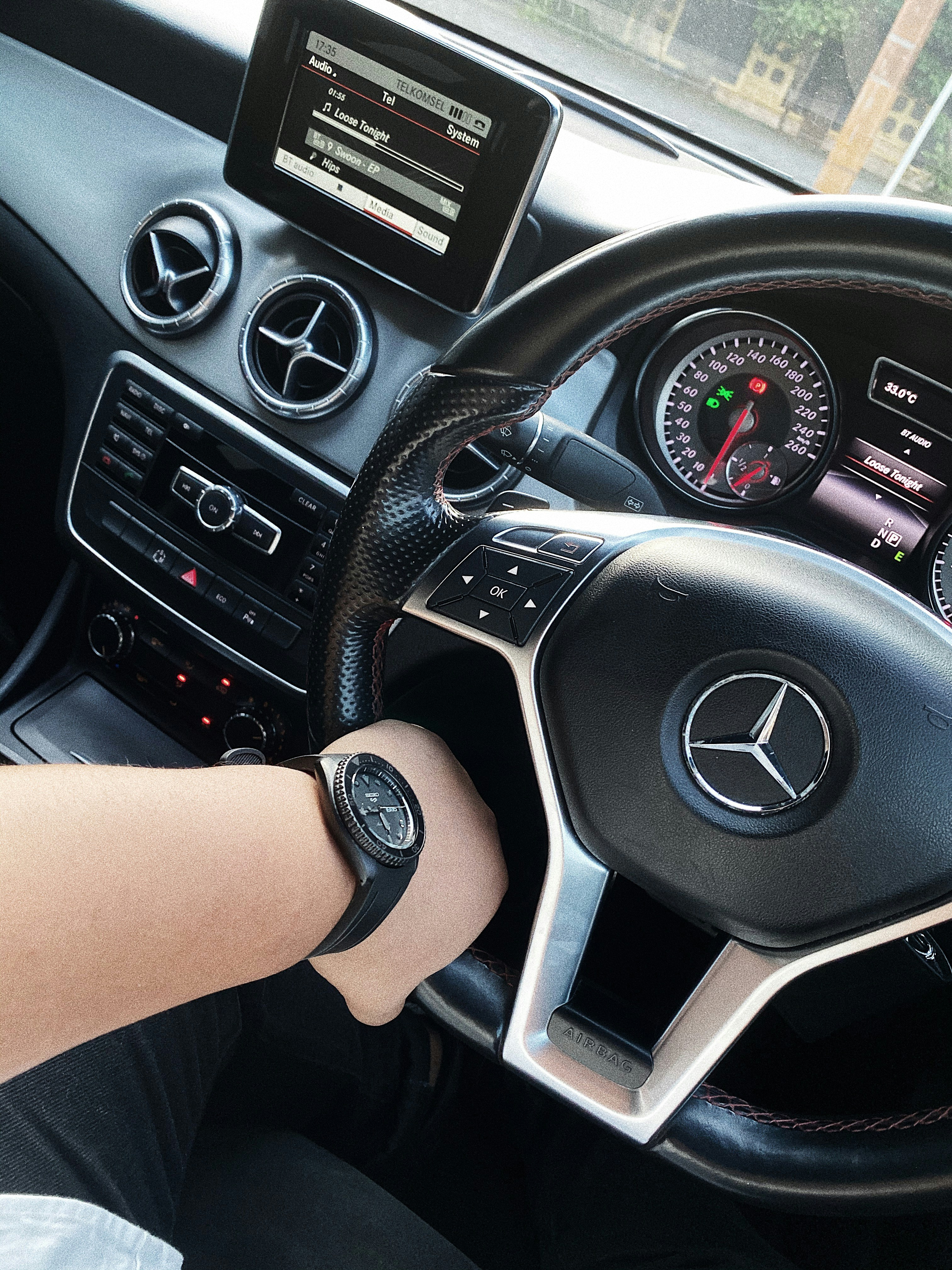 person driving black Mercedes-Benz vehicle