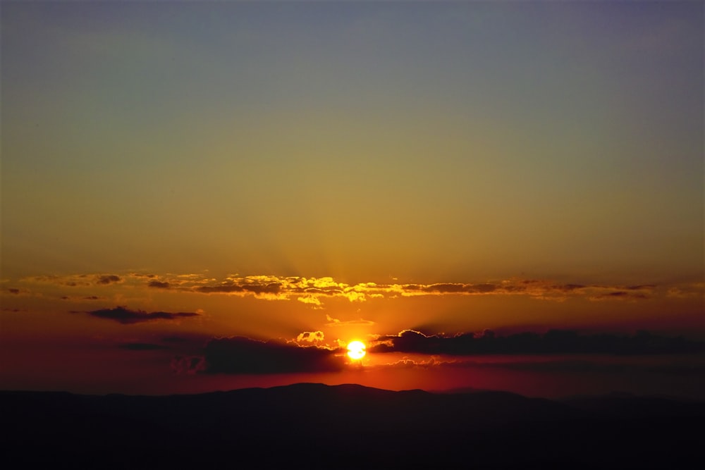 silhouette of mountain viewing full moon