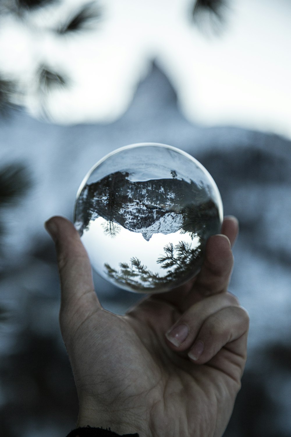 lensball photography of mountain covered with snow during daytime