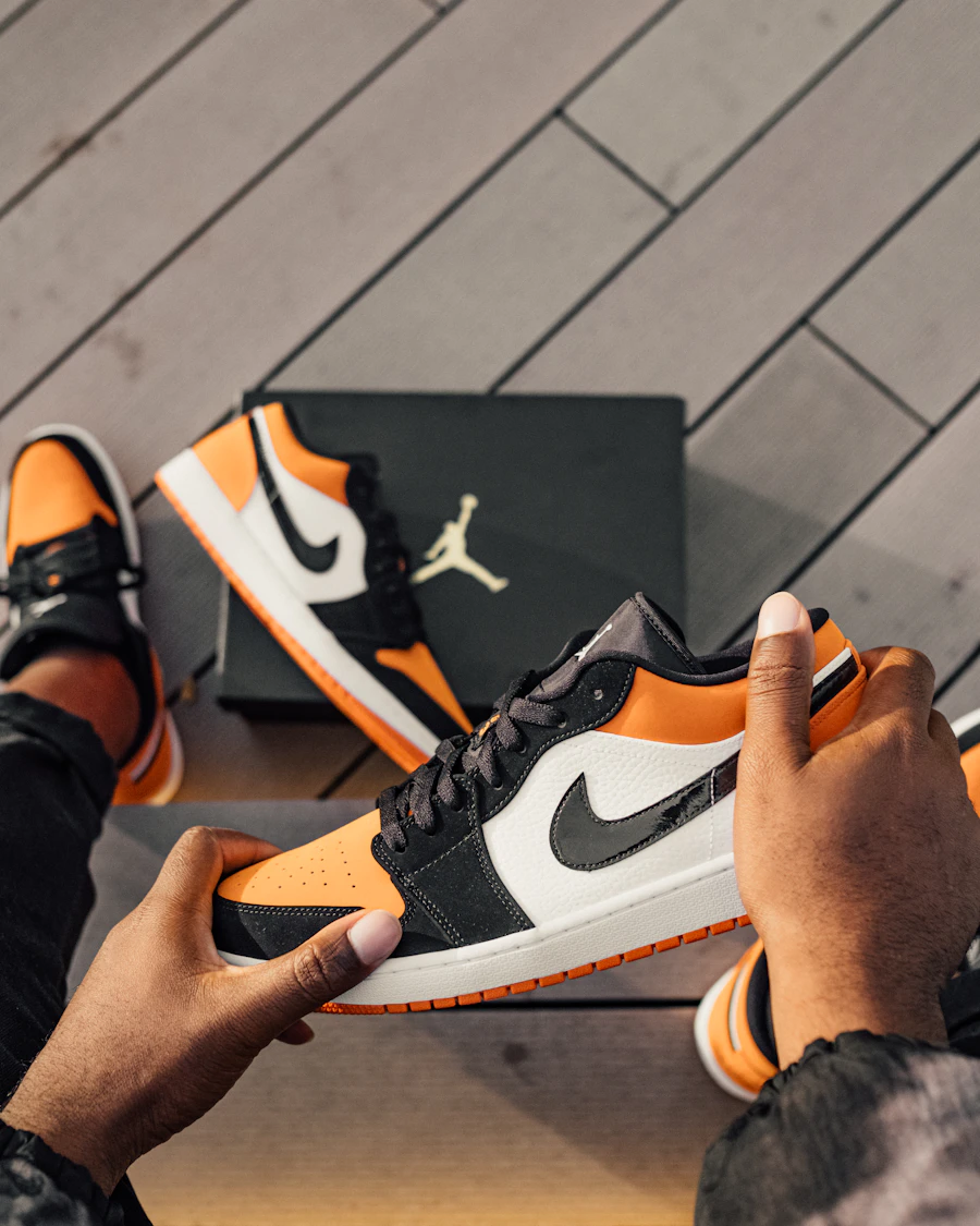 Hands holding a limited-edition sneaker — a drop offered direct to members