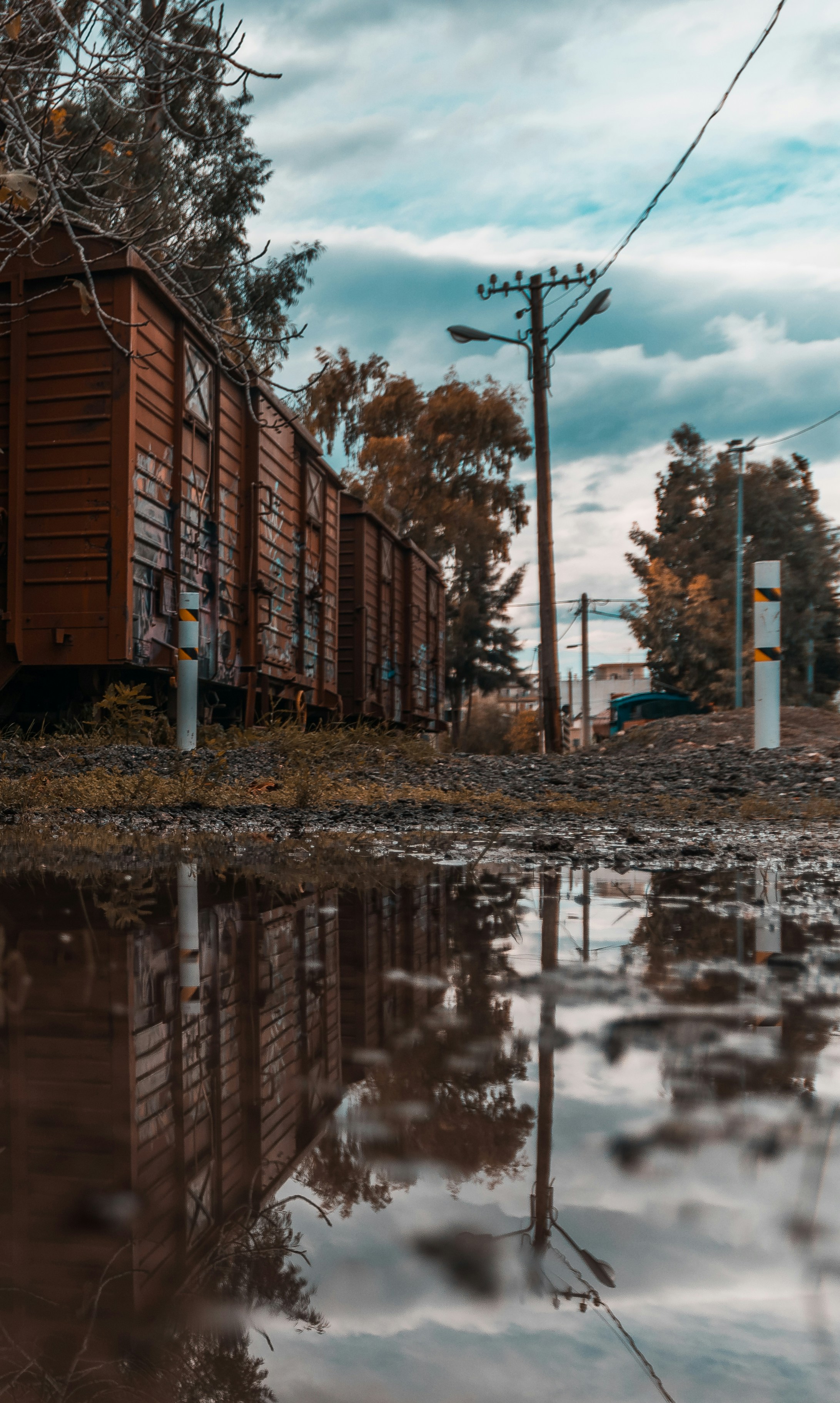 reflection of brown house on water puddle during daytime
