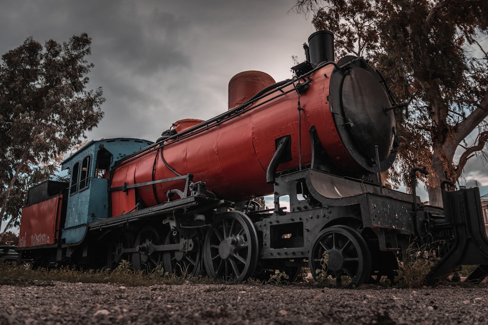 a red and blue train sitting on top of train tracks