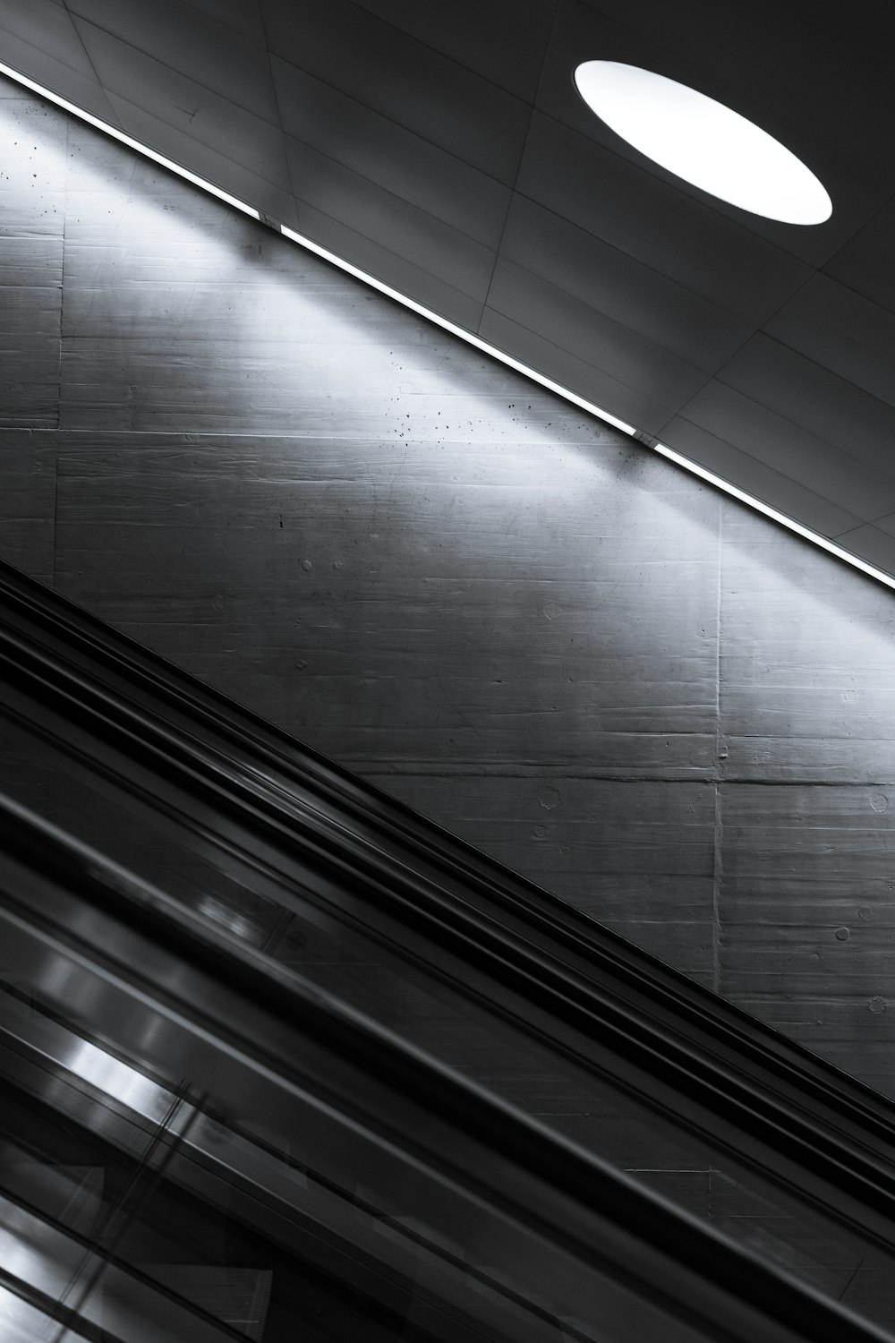 a black and white photo of an escalator