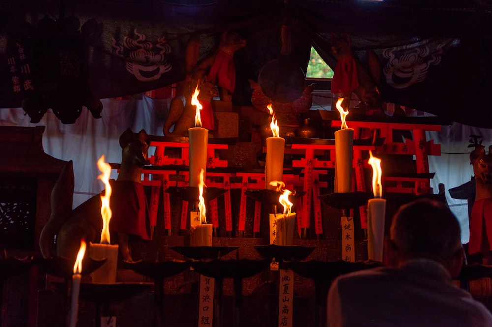 person near altar with light candles