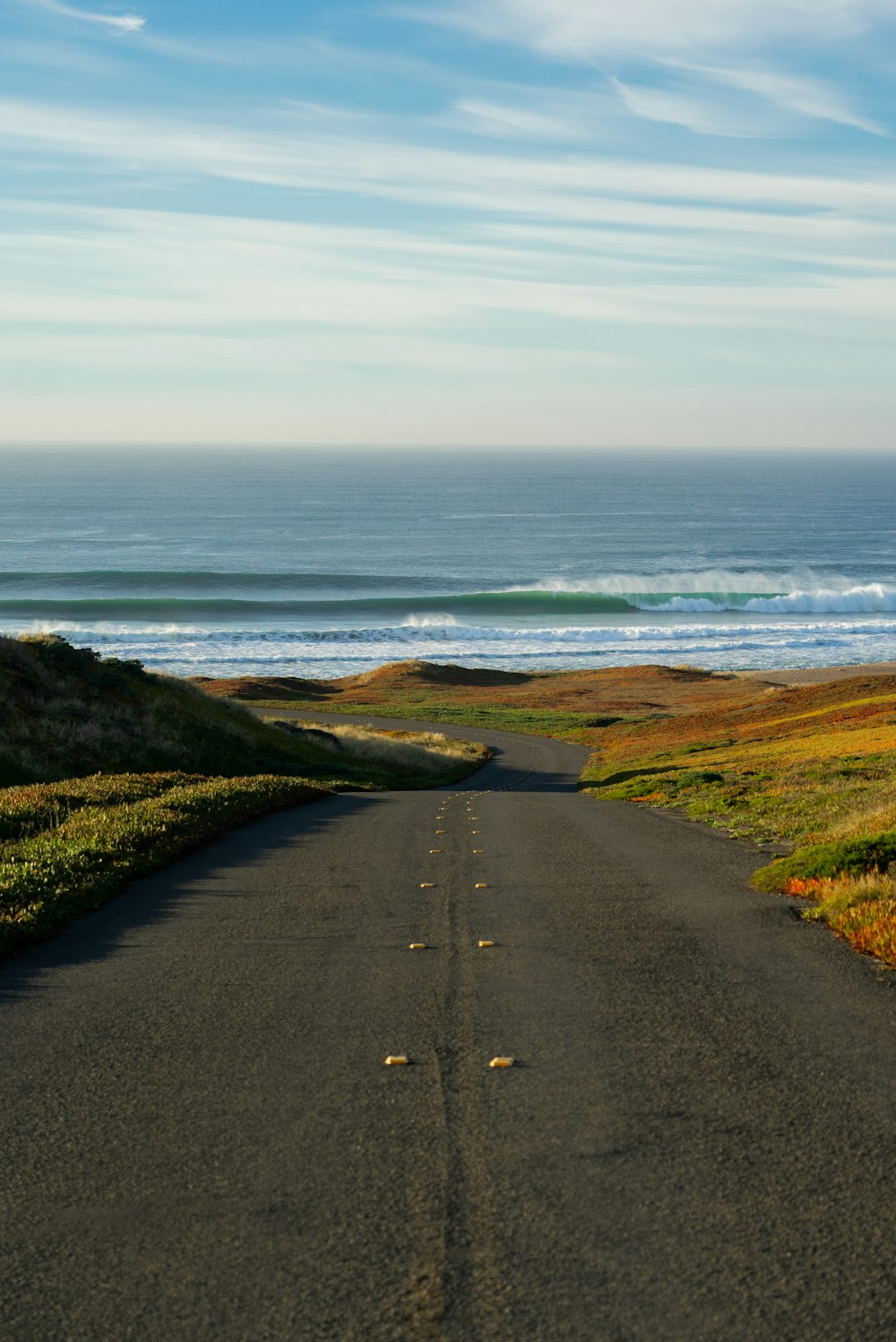 road and grass on island during day