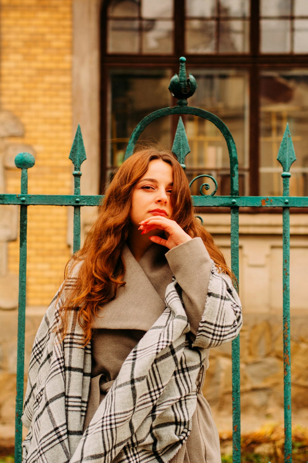 woman looking at the camera with left hand touching her chin