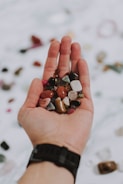 Close-up of hands holding natural stone materials used in the architecture process.