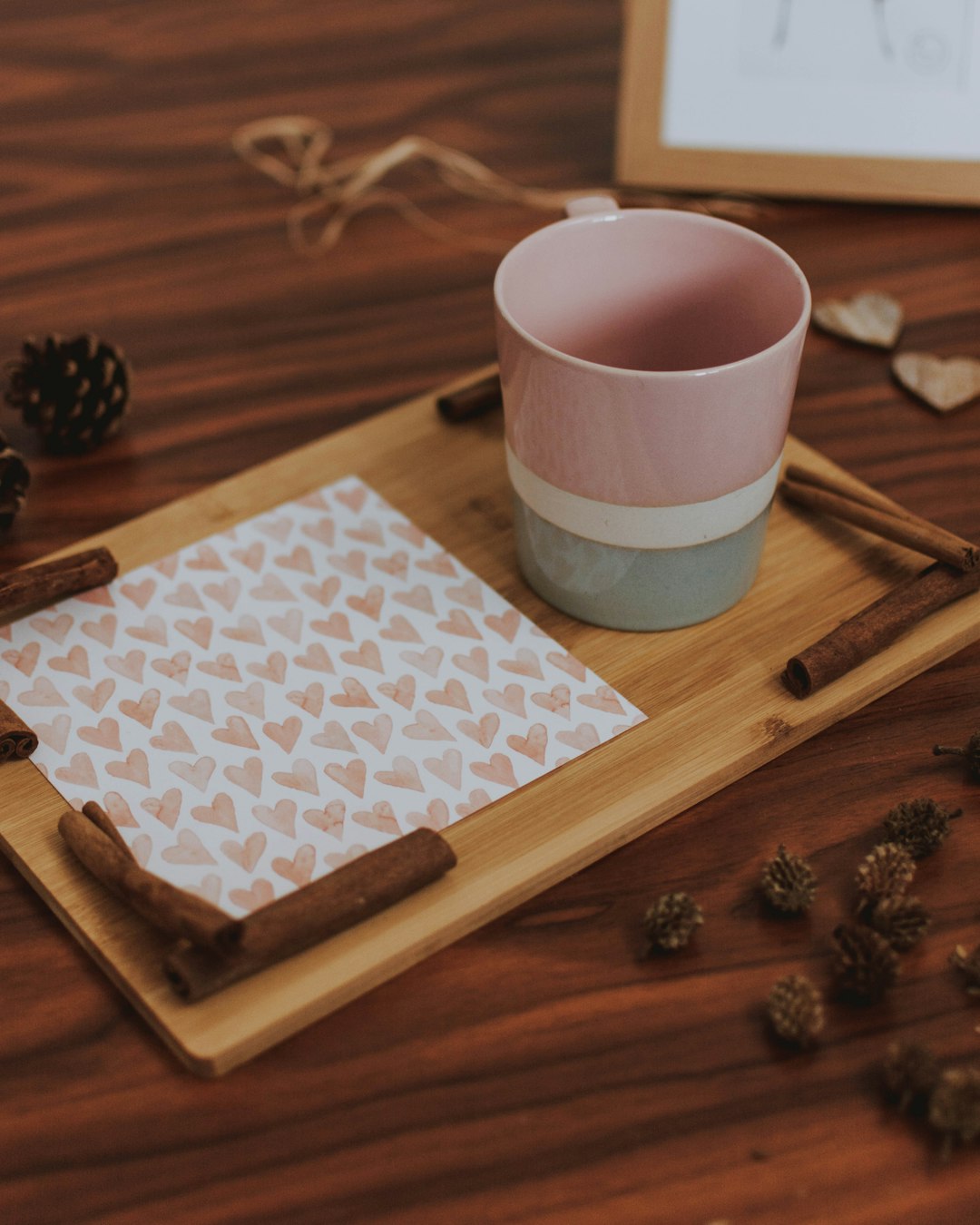 pink and white striped mug on brown wooden serving tray