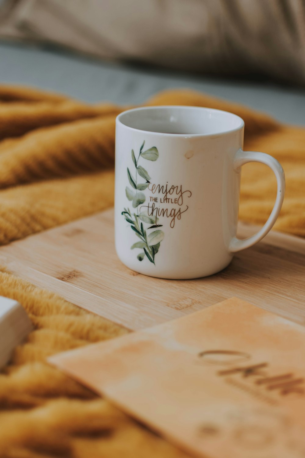 white mug on brown wooden board