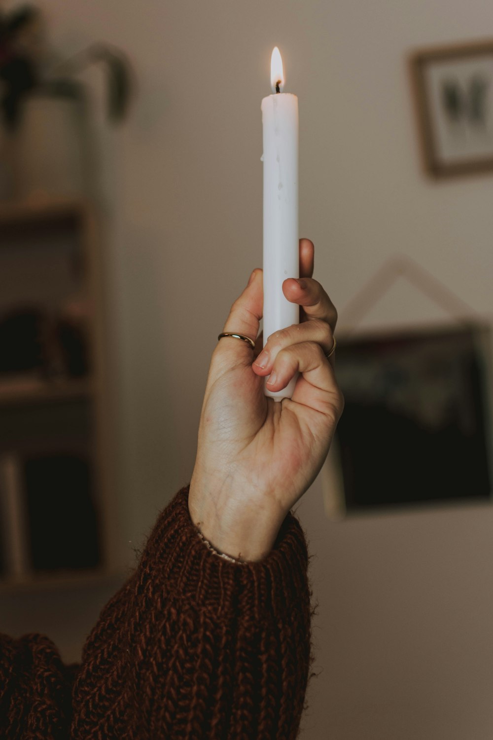 person holding lighted candle