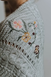 woman wearing gray and brown floral cardigan