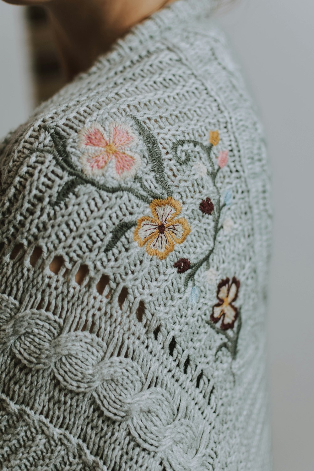 woman wearing gray and brown floral cardigan