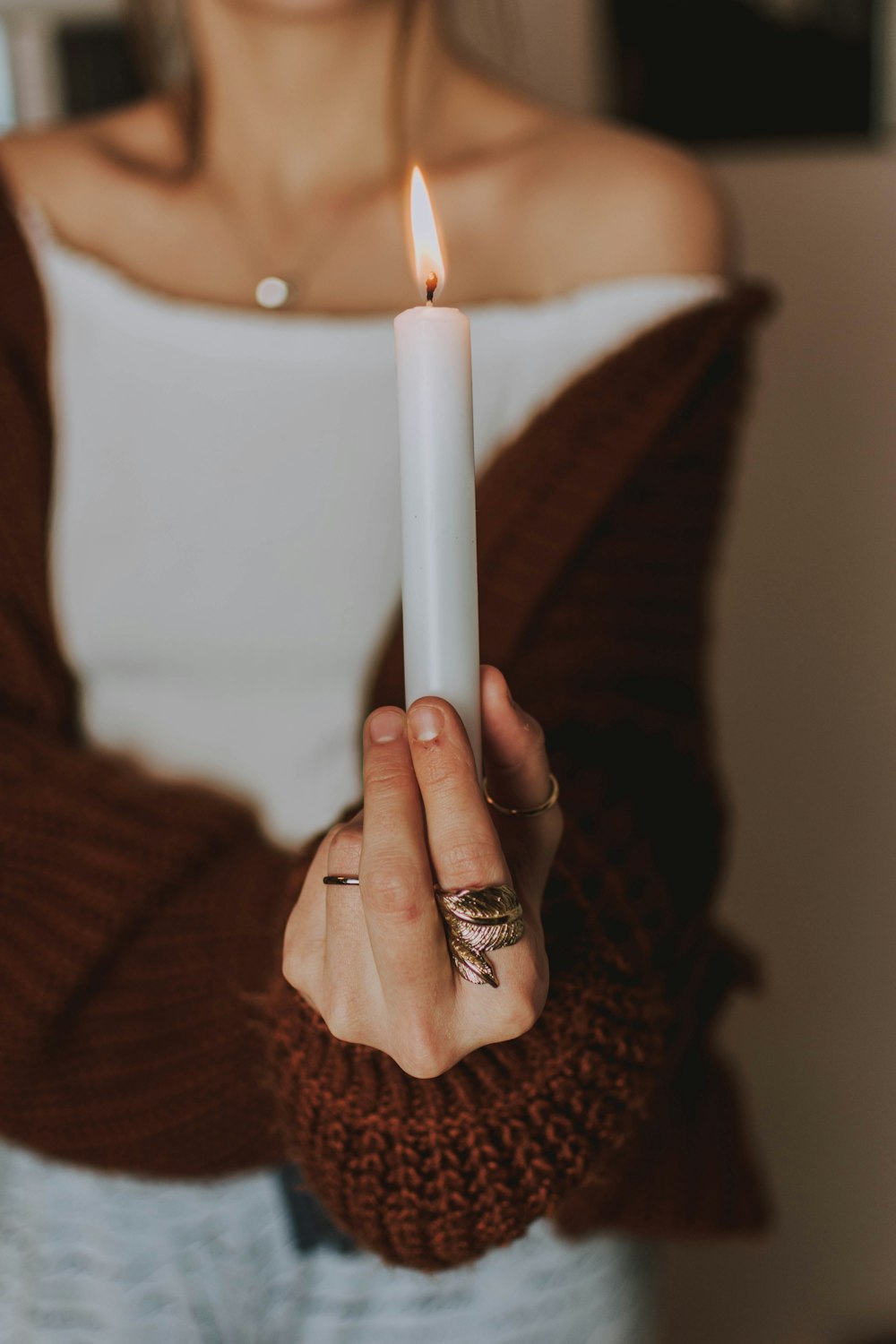 selective focus photography of woman holding lit candle
